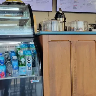a counter with drinks and menus
