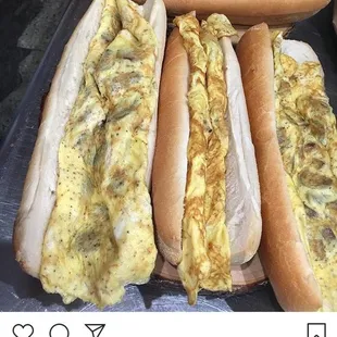 two hot dogs with cheese and onions