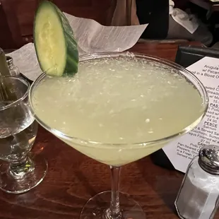 a cucumber martini on a table
