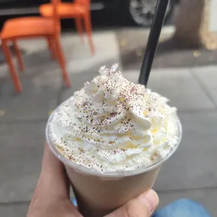 a hand holding a cup of coffee