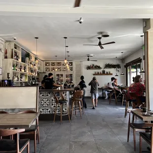 people sitting at tables in a restaurant