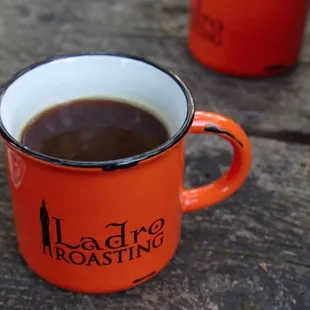 a cup of coffee on a picnic table