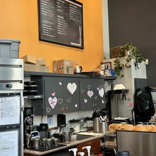 a coffee shop with a menu on the wall