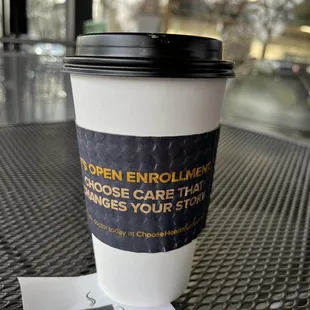 a cup of coffee and a receipt