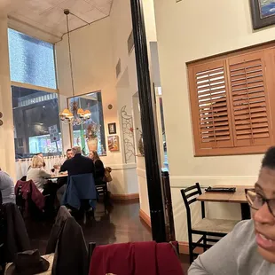 people sitting at tables in a restaurant