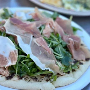 Truffled Prosciutto and arugula flatbread