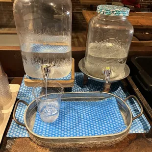 two glass jars with water in them