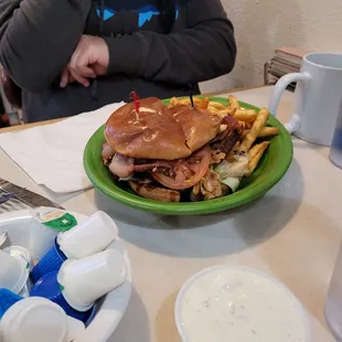 a person sitting at a table with a plate of food