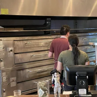 a man and a woman in a kitchen