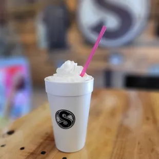 a cup of coffee with a straw