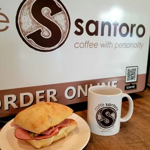 a sandwich and a coffee mug
