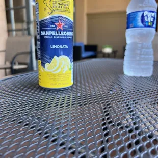 a can of lemonade and a bottle of water