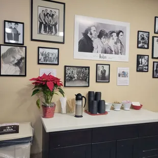 a coffee station with a coffee maker and coffee cups