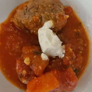 a plate of food with meatballs and vegetables