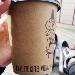 a person holding a coffee cup