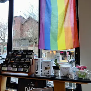 a rainbow flag hanging from a window