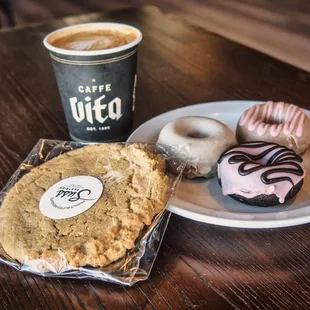 a plate of doughnuts and a cup of coffee