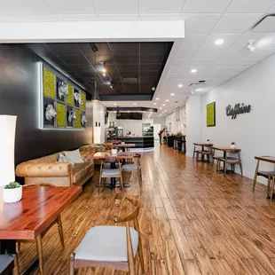 a coffee shop with wooden tables and chairs