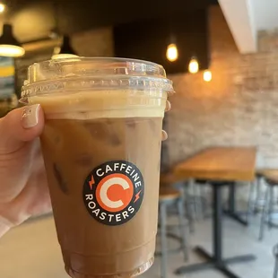 a hand holding a cup of coffee