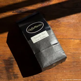 a bag of coffee on a wooden table