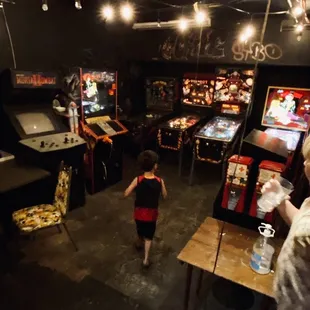 a woman playing a game of pinball