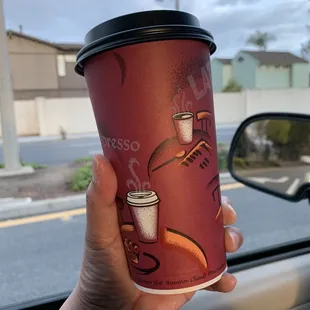 a hand holding a coffee cup