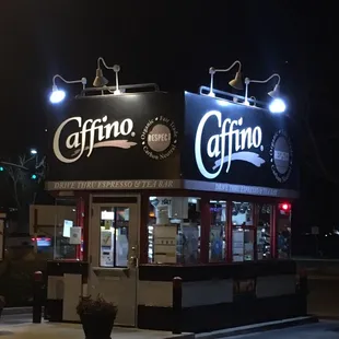 the outside of a coffee shop at night