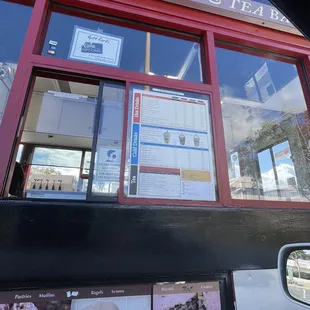 the reflection of the window of a coffee shop