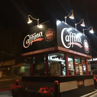 the exterior of a coffee shop at night
