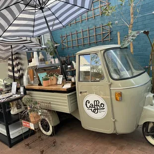 a coffee truck with a coffee cart on the back