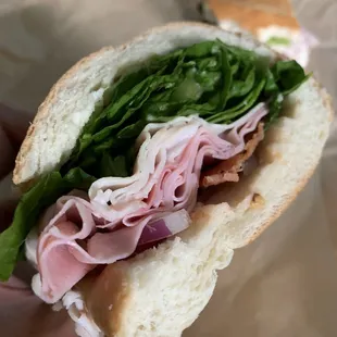 a hand holding a sandwich
