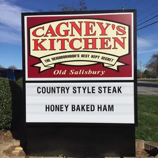a sign for a country style steak honey baked ham