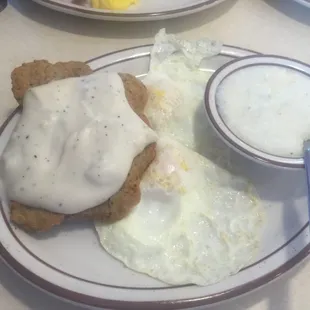 Country Fried Steak, 2 eggs over medium, excellent grits - a real Southern Breakfast.