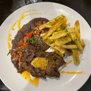a plate of steak and french fries
