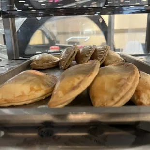 a tray of calzones on a counter