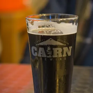 a pint of beer on a table