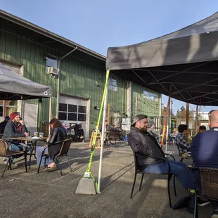 a group of people sitting under a canopy