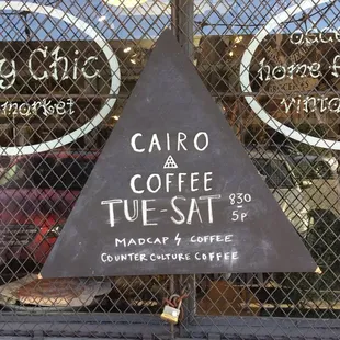 a triangle sign in front of a window