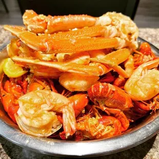 a bowl of crab legs and shrimp