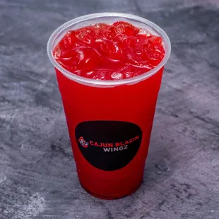 a red drink in a plastic cup