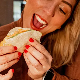 a woman eating a sandwich