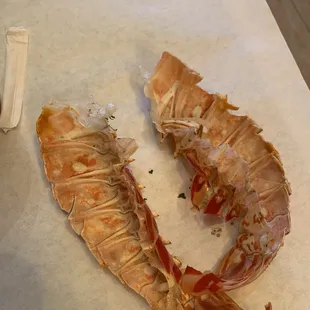 Trash empty shells put on top of dish to falsely advertise and make the picture look like it comes with lobster on top