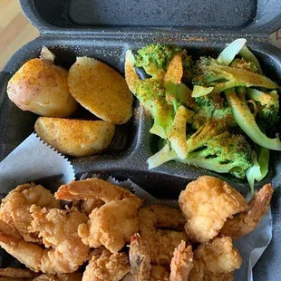 Fried jumbo shrimp with potatoes and broccoli