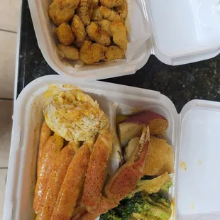 Gator bites and crab leg plate with potato and brocolli