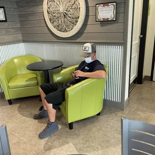 a man sitting in a green chair