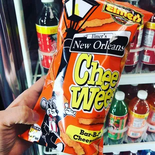 a hand holding a bag of chips