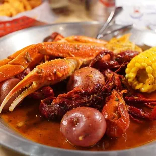 crab legs, corn and potatoes