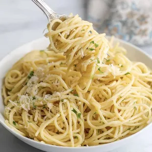 a bowl of spaghetti with parmesan cheese
