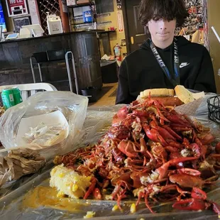 a man sitting at a table covered in craws