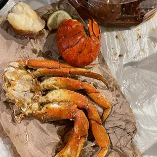 a crab and a potato on a cutting board